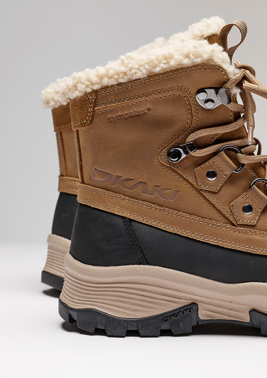 Brune vintersko med pelskant, snøring og kraftig såle, designet for vinterforhold.